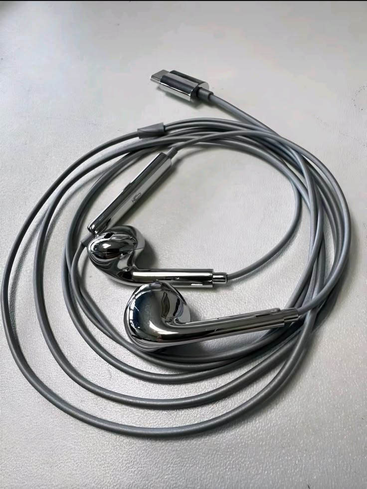 Phantom Platinum chrome earphones with USB-C connector on a light surface